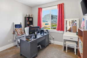 Carpeted office space with baseboards