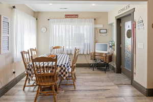 Dining area featuring light wood-style flooring and recessed lighting
