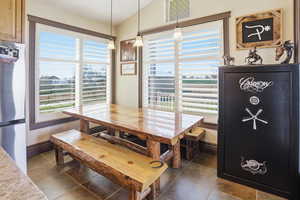Dining room with baseboards and vaulted ceiling