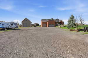 View of yard with driveway and an outbuilding