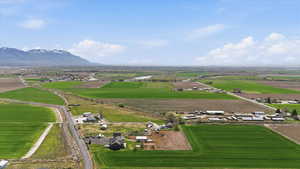 Aerial view of sparsely populated area featuring abundant farmland and mountains