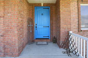 Entrance to property with brick siding