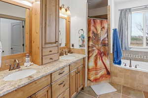 Full bathroom with double vanity, curtained shower, a bath, and tile patterned floors