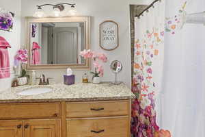 Bathroom featuring vanity and a shower with curtain