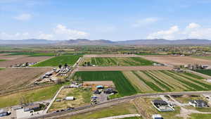 View of rural area with rows of crops and mountains