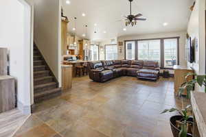 Living area with ceiling fan, recessed lighting, and lofted ceiling