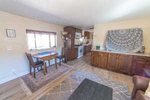 Dining area with light wood-style flooring and baseboards