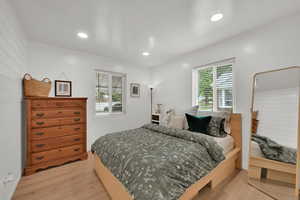 Bedroom with light wood finished floors and recessed lighting