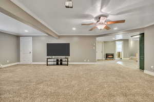 Unfurnished living room with a ceiling fan, crown molding, light colored carpet, and recessed lighting
