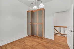 Unfurnished dining area with light wood-style floors and baseboards
