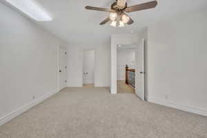 Unfurnished bedroom with light carpet and ceiling fan