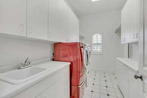 Laundry room featuring cabinet space and washing machine and dryer