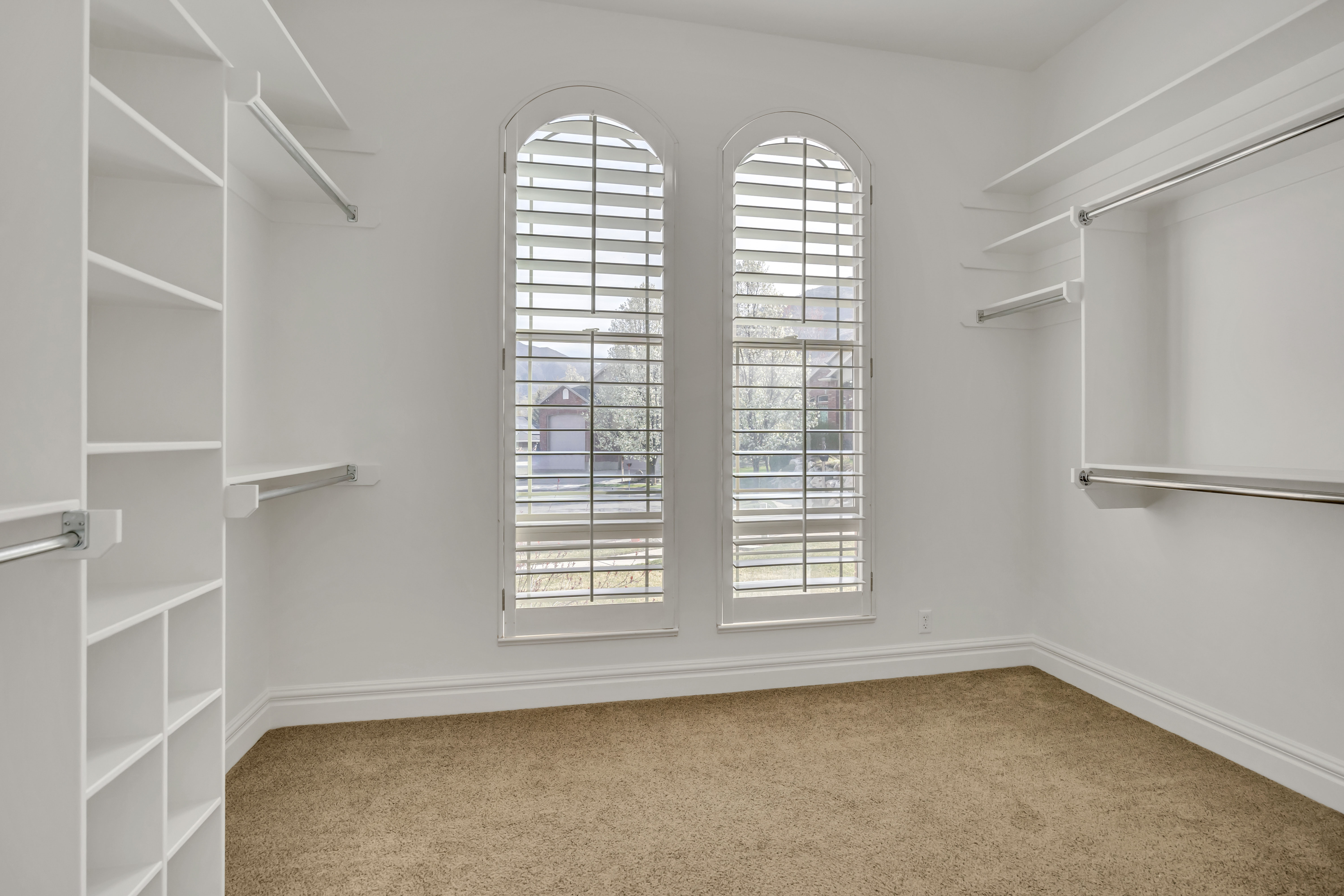 Walk in closet featuring light carpet