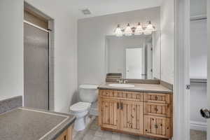 Full bathroom with vanity, a stall shower, and light tile patterned flooring