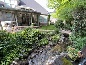 View of green lawn featuring a ceiling fan, a pergola, and a patio area