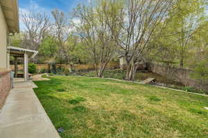 Fenced backyard featuring a patio