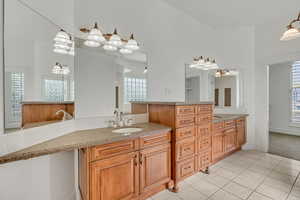 Bathroom with two vanities and light tile patterned flooring