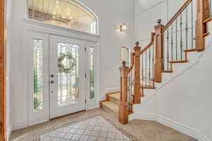 Entryway featuring inlaid floor details and light tile patterned floors