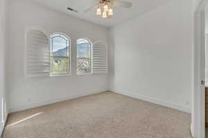 Unfurnished room with light carpet, ceiling fan, and a mountain view