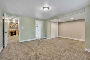 Unfurnished bedroom featuring light colored carpet and a closet