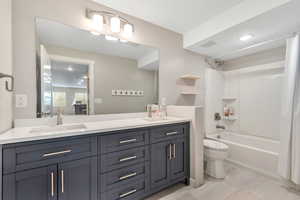 Bathroom with double vanity, shower / bath combo with shower curtain, recessed lighting, and ensuite bath