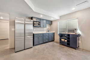 Kitchen with stainless steel appliances, recessed lighting, light countertops, and concrete floors