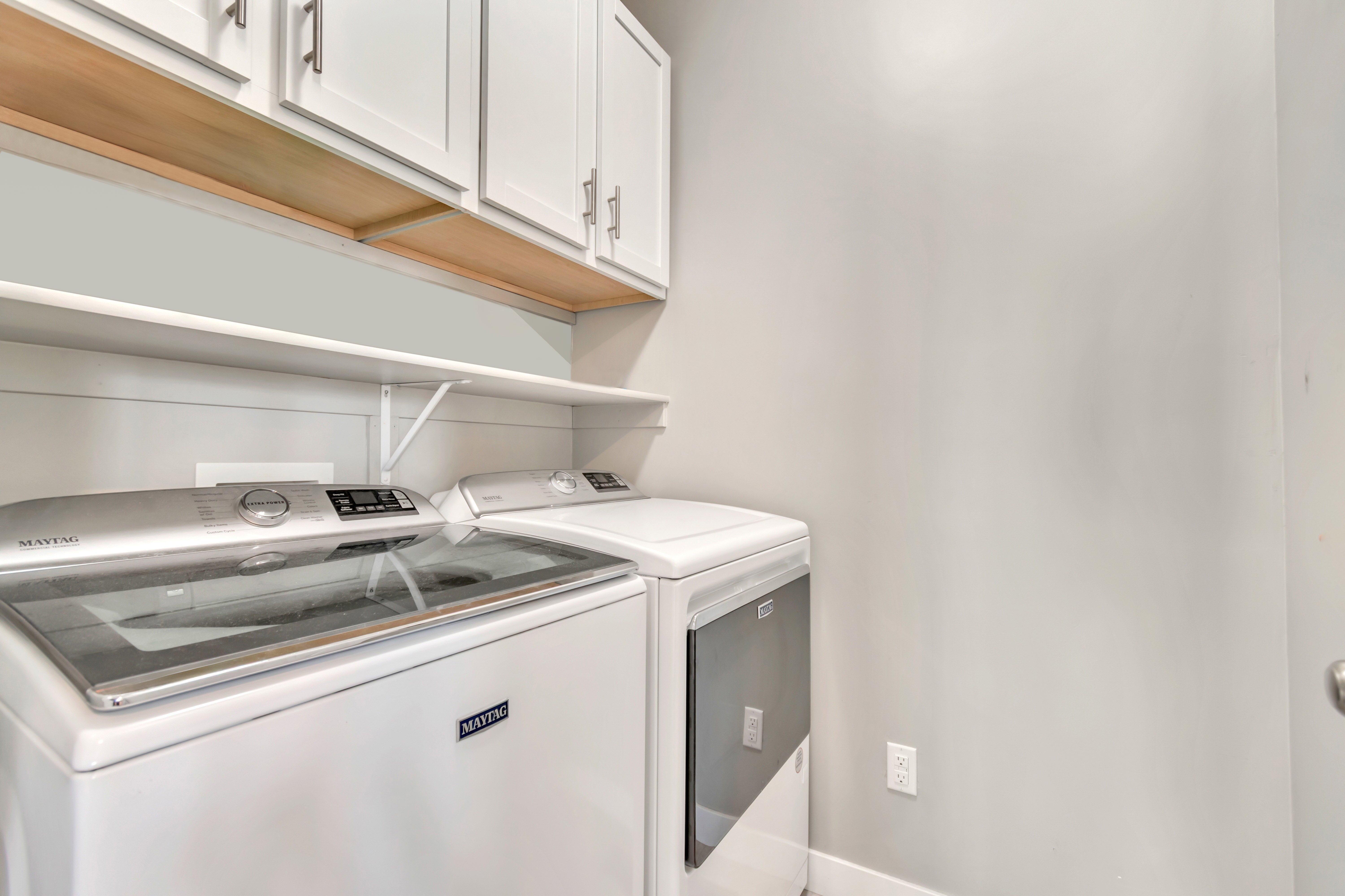 Laundry area with cabinet space and independent washer and dryer