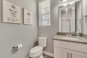 Bathroom featuring vanity and dark wood finished floors