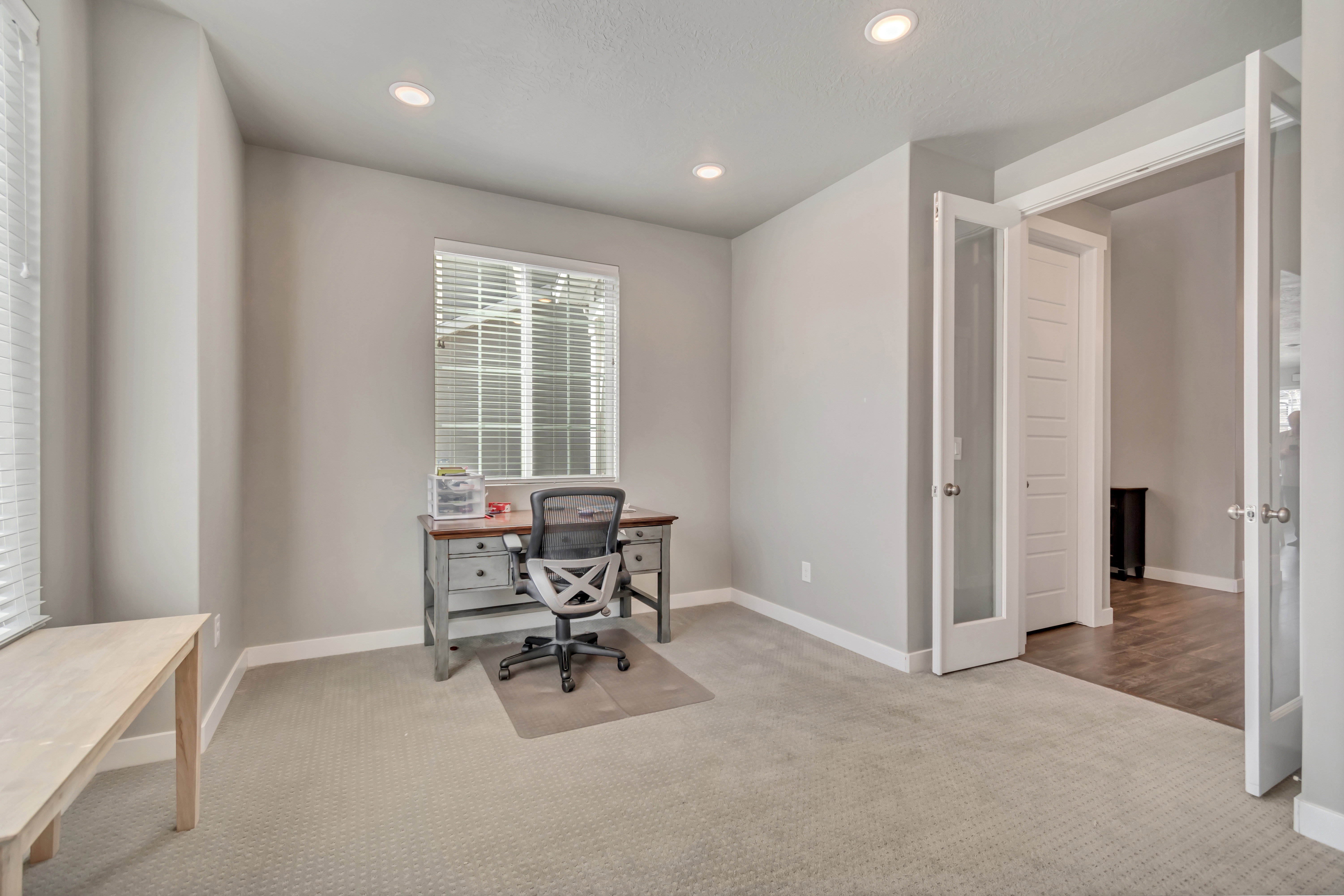 Office space featuring light colored carpet and recessed lighting