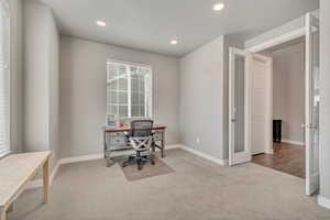 Office space featuring light colored carpet and recessed lighting