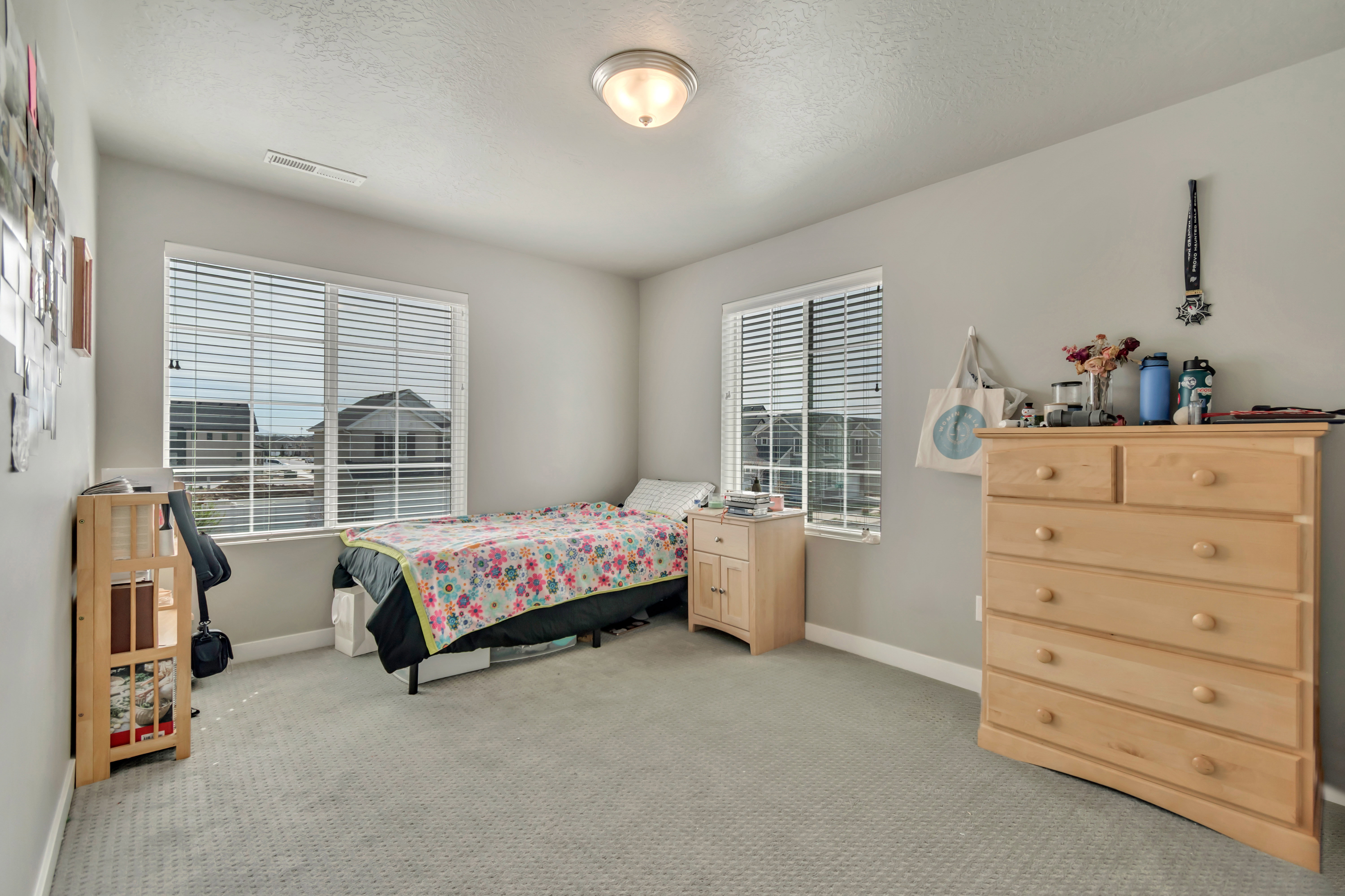 Bedroom with light colored carpet and a textured ceiling