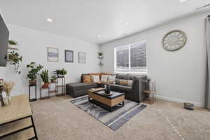 Living room featuring carpet and recessed lighting