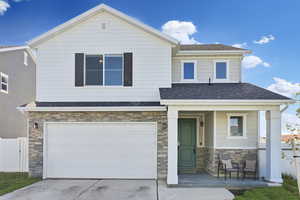 Craftsman-style home featuring stone siding, covered porch, a shingled roof, and an attached garage