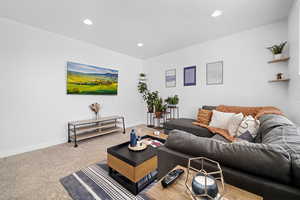 Carpeted living area featuring recessed lighting