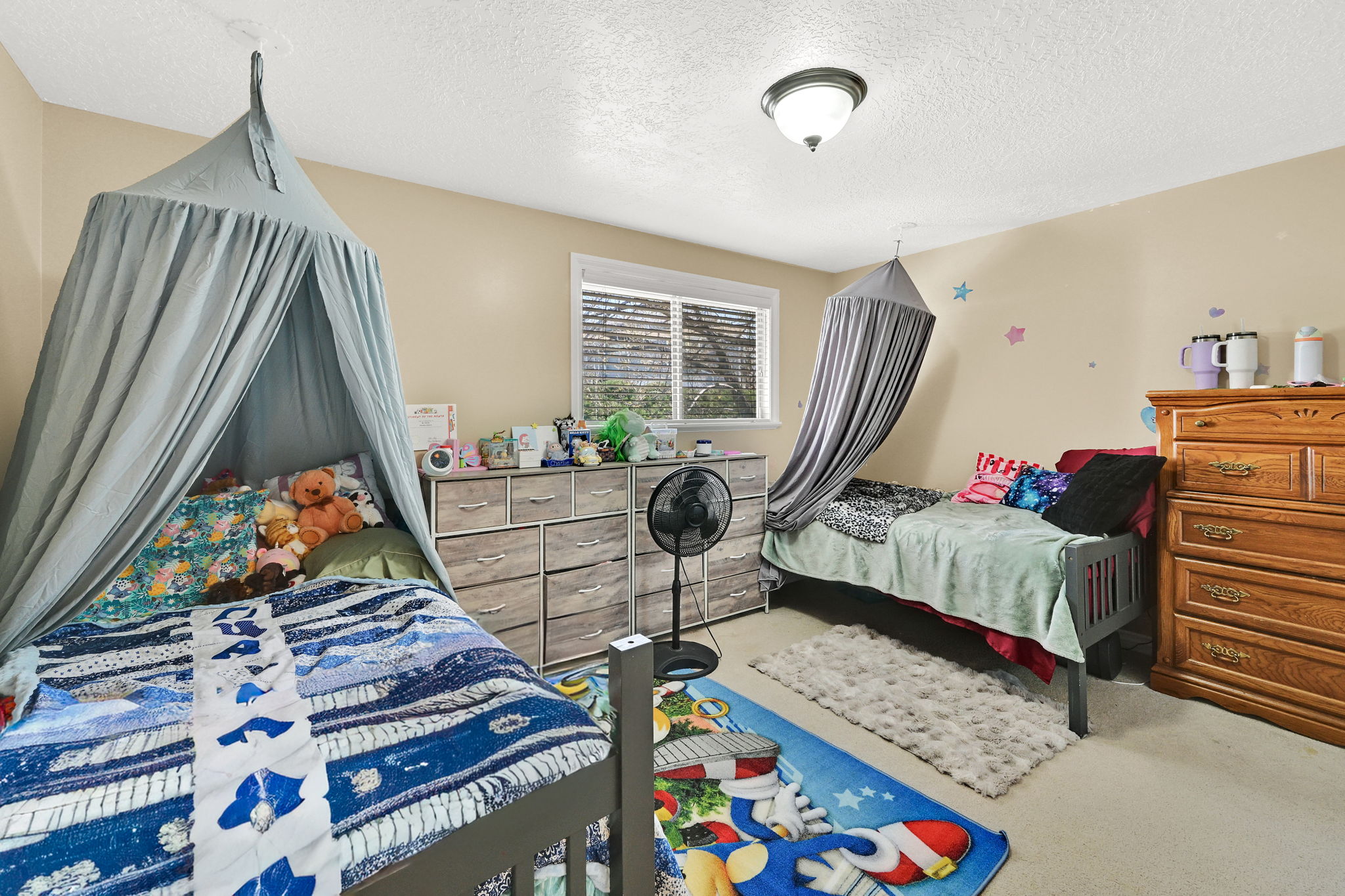 Carpeted bedroom with a textured ceiling