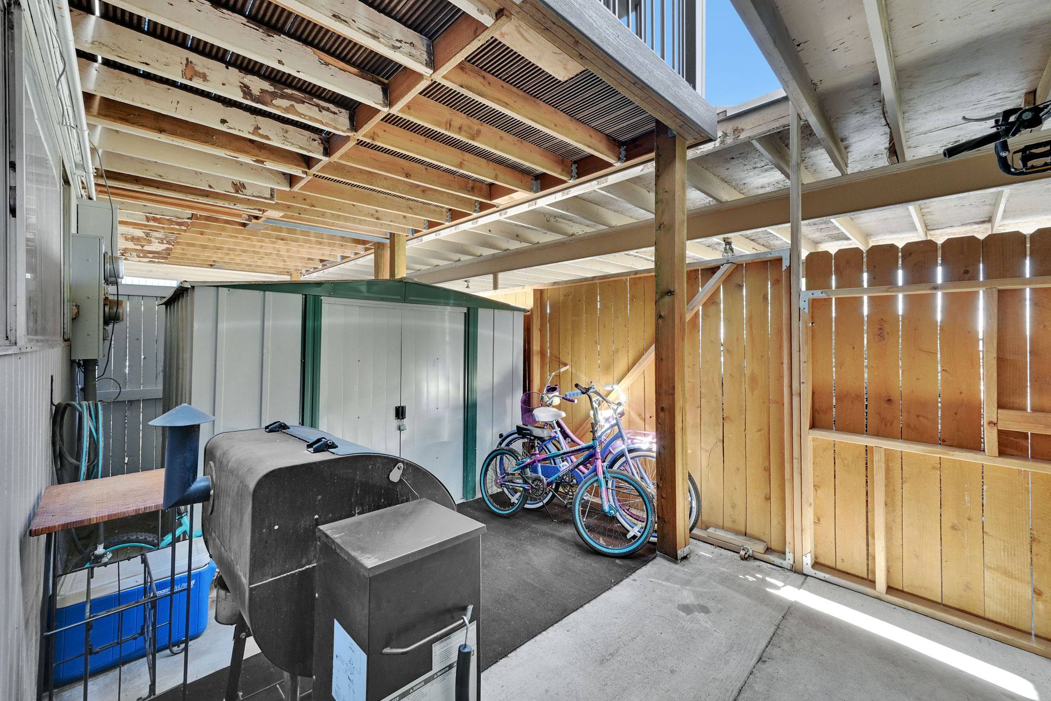 View of patio featuring a storage unit