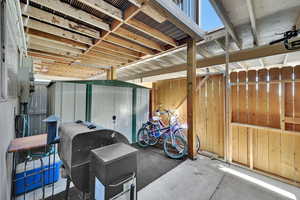 View of patio featuring a storage unit