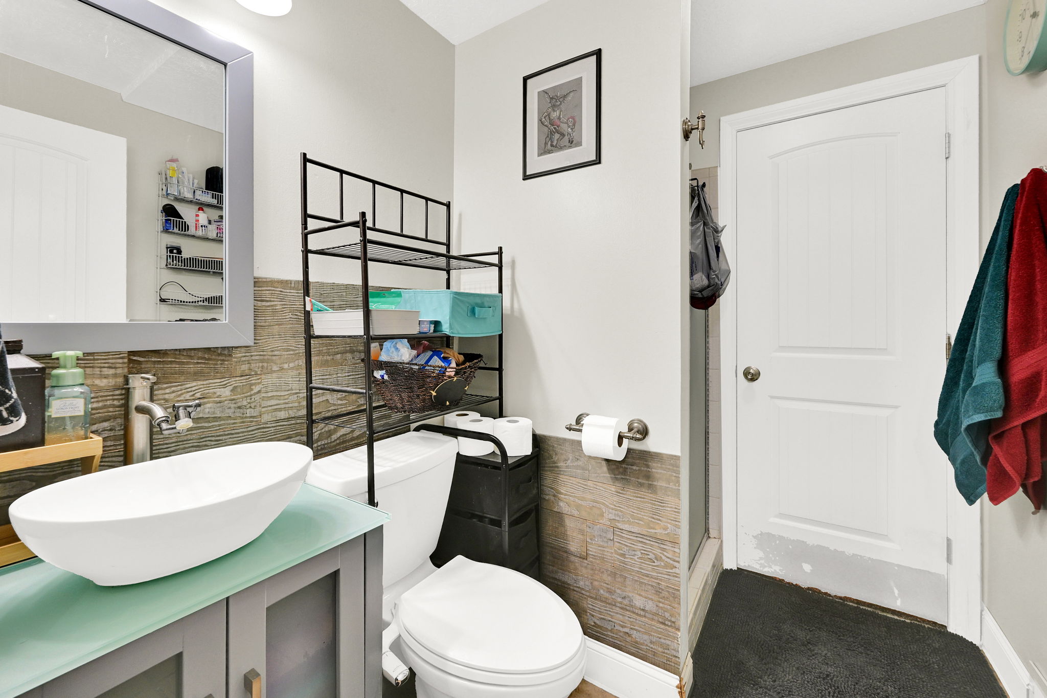 Bathroom featuring vanity, tile walls, and walk in shower