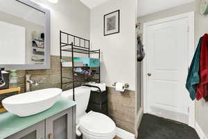 Bathroom featuring vanity, tile walls, and walk in shower