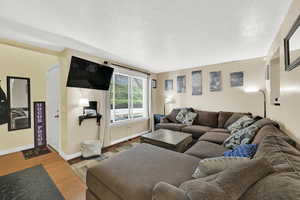 Living room featuring a textured ceiling and wood finished floors
