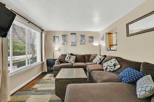 Living area featuring wood finished floors and a textured ceiling