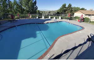 Community pool with a patio