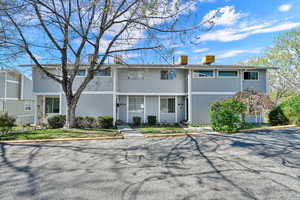 Mid-century modern home featuring a chimney and a balcony