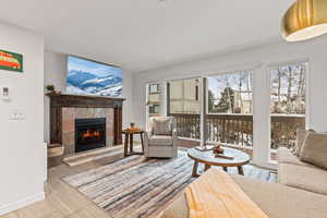 Living room with a fireplace and baseboards