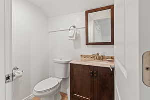 Half bathroom with vanity and toilet