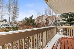 Snow covered back of property with a residential view
