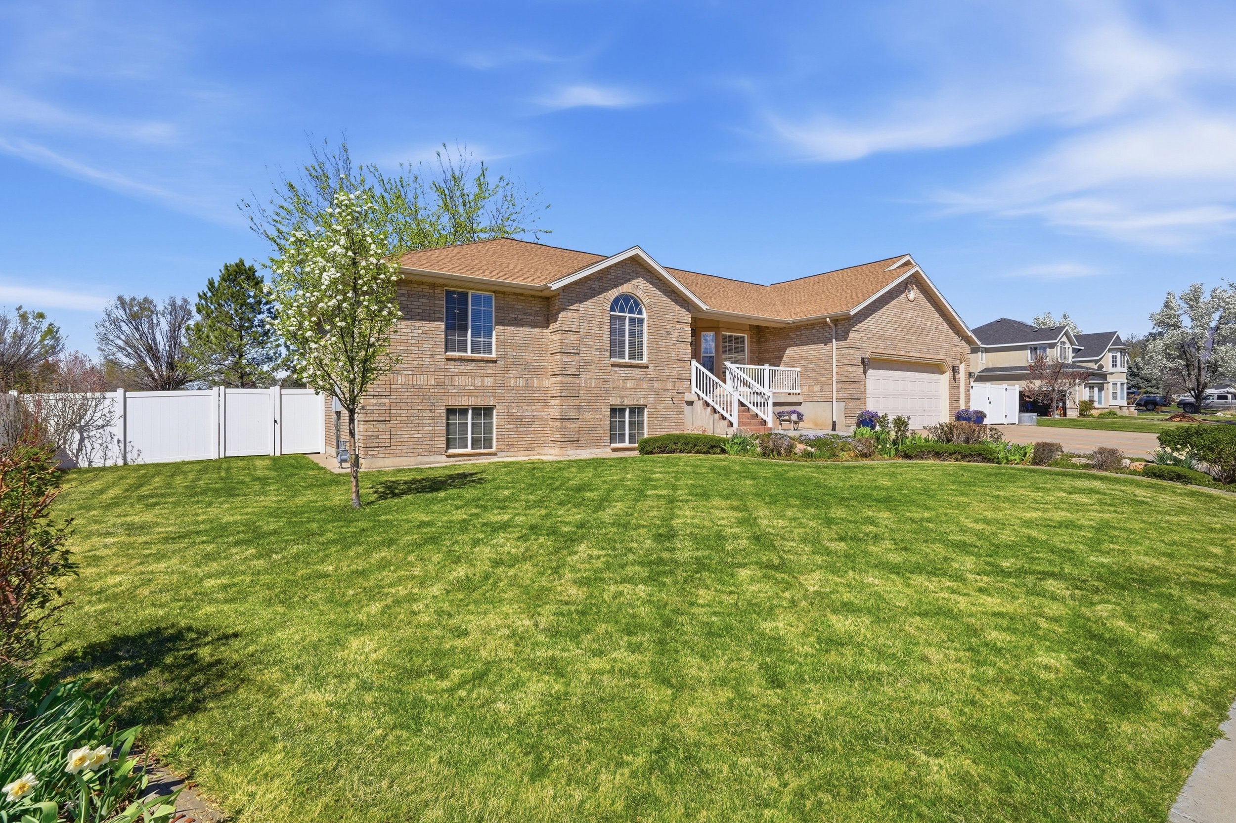 View of front of property with brick siding and a garage