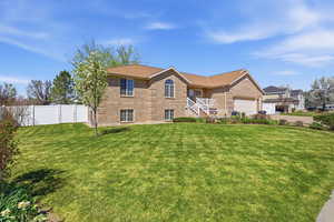 View of front of property with brick siding and a garage