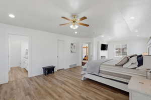 Bedroom with ensuite bathroom, light wood-style floors, recessed lighting, and ceiling fan