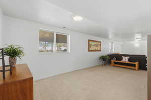 Sitting room featuring light colored carpet